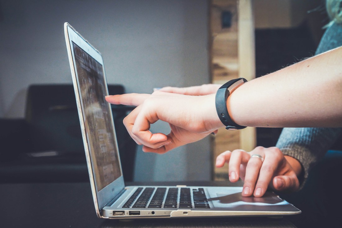 People sharing ideas and learning together around a laptop